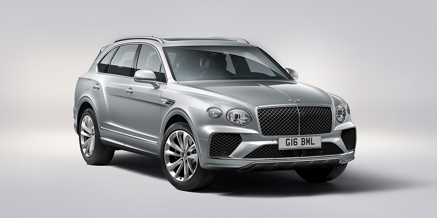 Bentley Marbella Bentley Bentayga in Moonbeam paint, front three-quarter view, featuring a matrix grille and elliptical LED headlights.