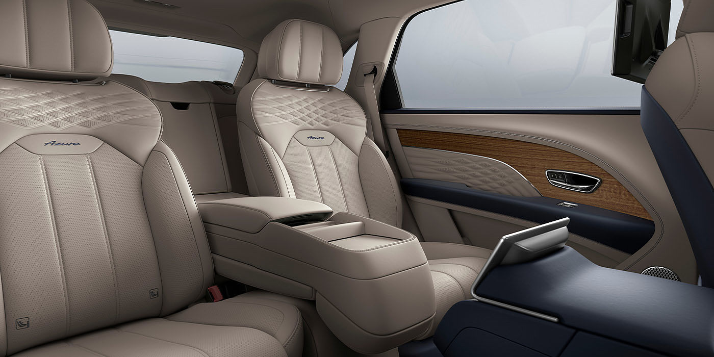 Bentley Marbella Bentley Bentayga EWB Azure interior view for rear passengers with Portland hide featuring Azure Emblem in Imperial Blue contrast stitch.