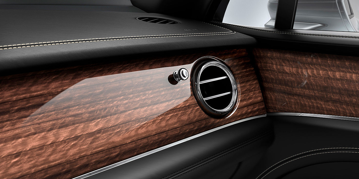 Bentley Marbella Bentley Bentayga front interior Crown Cut Walnut veneer and chrome air vent.