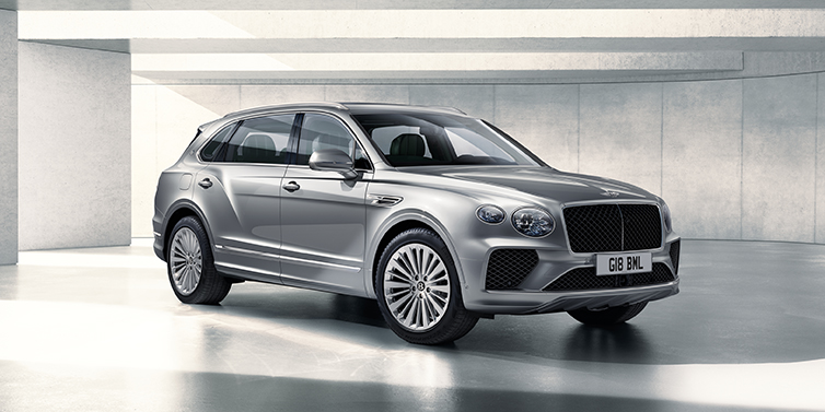 Bentley Marbella Bentley Bentayga Extended Wheelbase SUV front three quarter in Moonbeam paint with a grey background