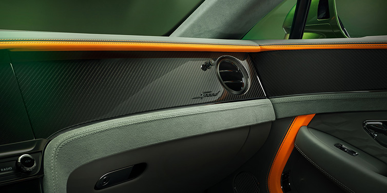 Bentley Marbella Bentley Continental GT Speed coupe front interior dash detail with high gloss carbon fibre veneer surrounded by Mandarin by Mulliner and Gravity Grey hides