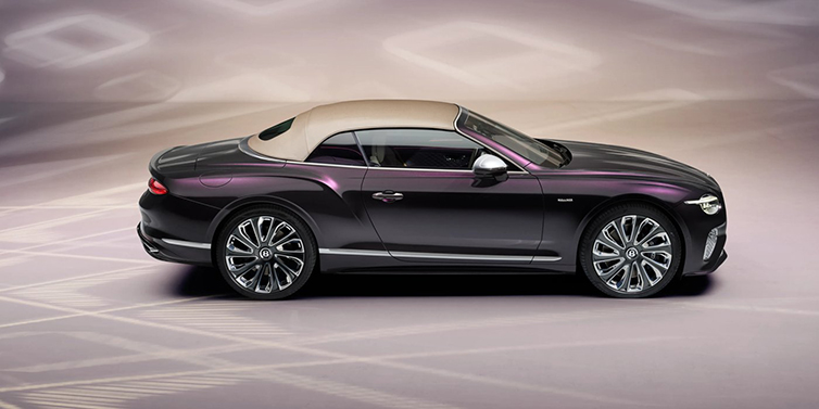 Bentley Marbella Bentley Continental GTC Mulliner convertible in profile with hood up, in Tanzanite Purple paint and 22 inch Mulliner painted and polished wheels