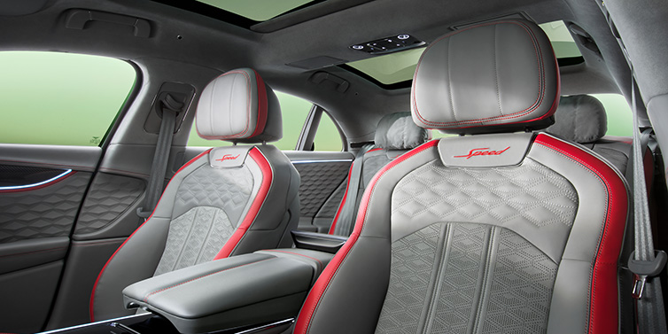 Bentley Marbella Bentley Flying Spur Speed sedan interior showing front and rear seats in Hotspur red and Gravity Grey hides, with Speed seat emblems