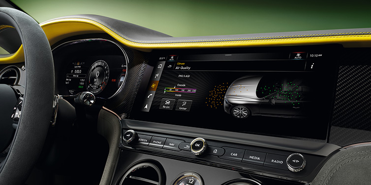 Bentley Marbella Bentley Continental GTC Speed convertible front interior centre console with MMI screen showing Air Quality visualisation surrounded by Cyber Yellow by Mulliner and Gravity Grey hides and high gloss carbon fibre veneer