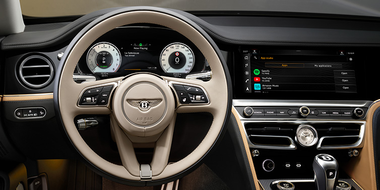 Bentley Marbella Bentley Flying Spur Mulliner sedan front interior detail of steering wheel and driver screens surrounded by Linen and Beluga black hides