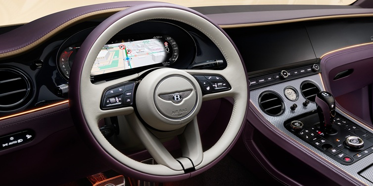 Bentley Marbella Bentley Continental GT Mulliner coupe front interior showing steering wheel and drivers screens surrounded by Linen and Damson hides and Grand Black veneer